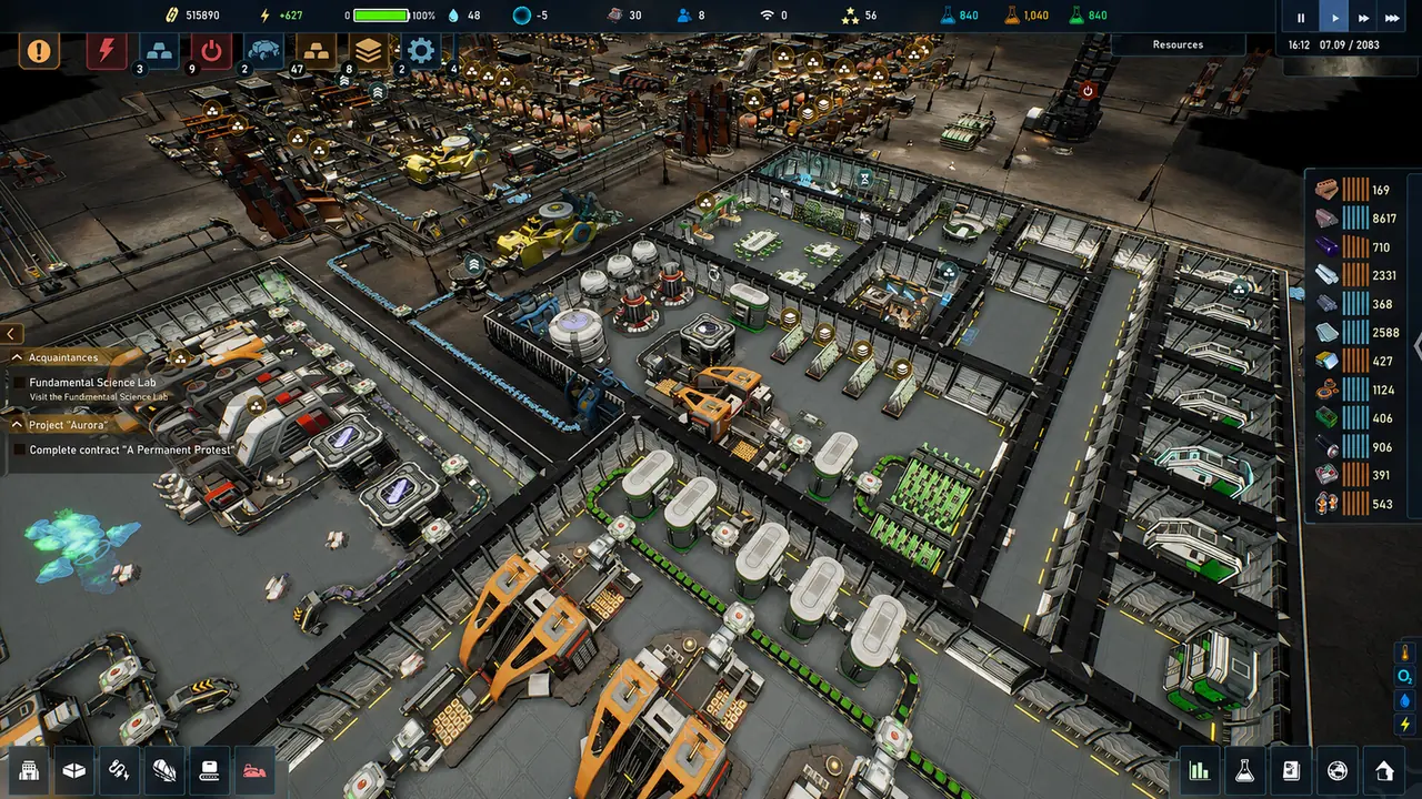 A top-down daylight view of a colony, with conveyor lines and orange machinery