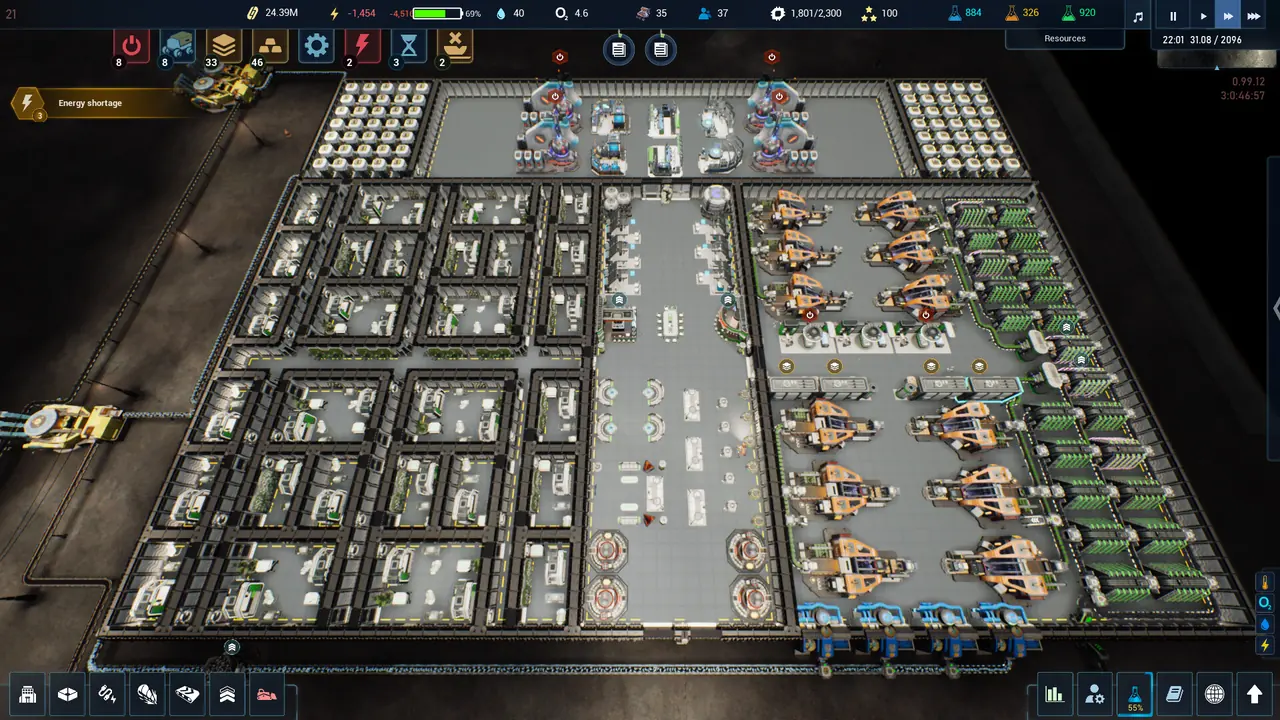 A top-down layout view of a gridded colony, with rooms carved out in a rectangular plan and an energy-shortage warning on screen