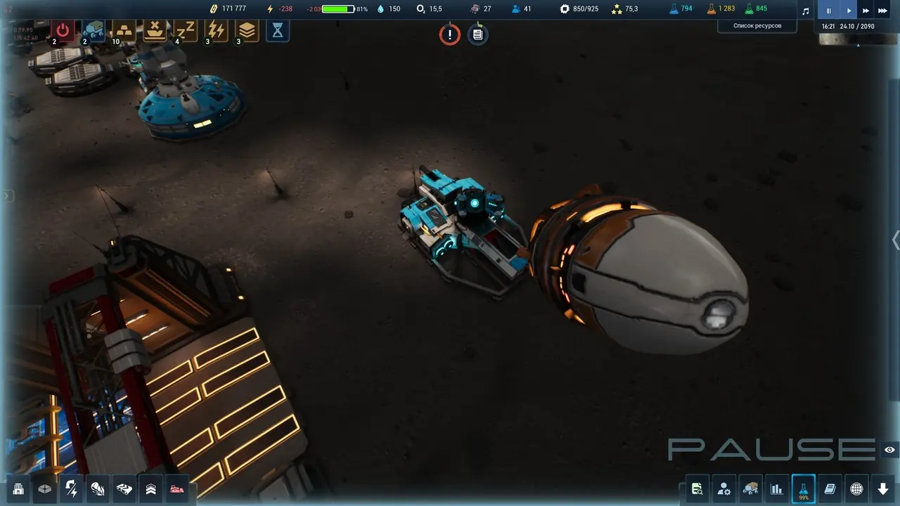 A blue-and-cyan rover towing a large spherical cargo capsule across the lunar surface, with an industrial building lit by orange panel lights on the left